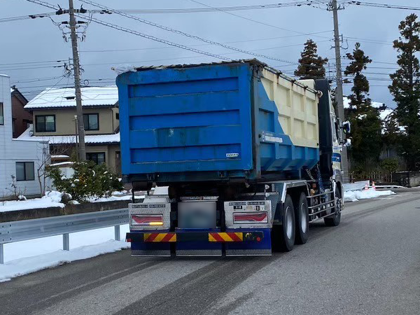 アスベスト廃棄袋を載せたダンプカーが処理場へ向かう