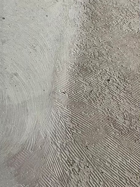 アスベスト含有下地材の除去後と除去前。左はアスベストが除去されて滑らかで、右は細かい溝が筋のように入ってざらざらしたアスベスト下地材が残っている。