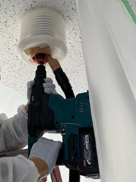 電動ドリルが天井に穴を開けている