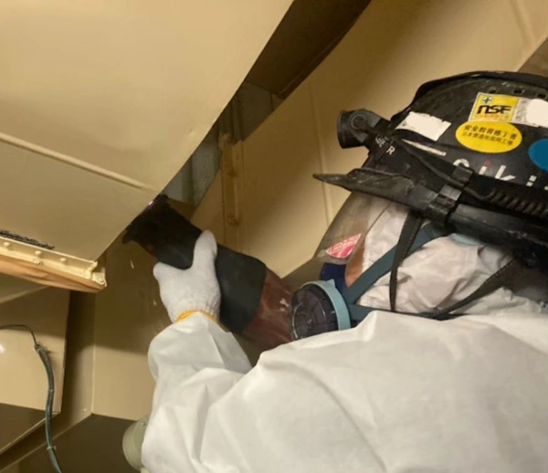 富山のアスベスト業者、エイキの作業員が空調ダクトのアスベストを除去している様子