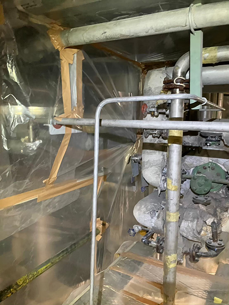 アスベスト保温材除去の為に、負圧隔離養生された機械室。