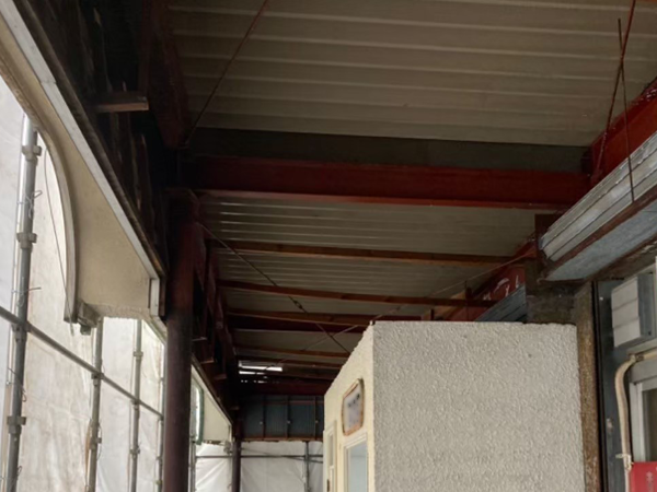 吹き付けアスベストが除去された状態の屋根裏と鉄骨梁1。