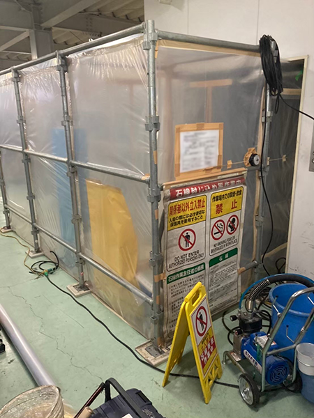 エアシャワーが置かれたセキュリティゾーンを外から見た状態。シートから内部のエアシャワーが薄く見える。