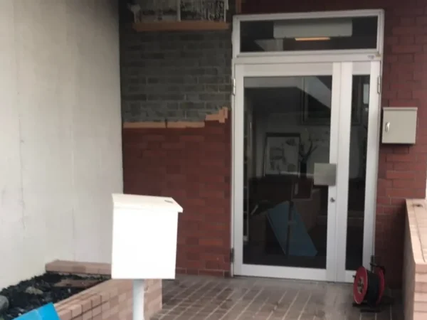 株式会社エイキが富山でレンガ状の壁タイルを解体。4分の1ほどのタイルが落ちている状態