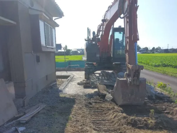 油圧ショベルを使って基礎コンクリートを一か所にまとめている。