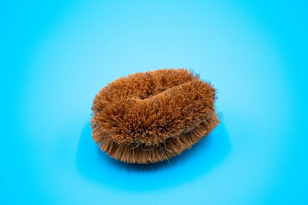 青い背景に置かれているたわし